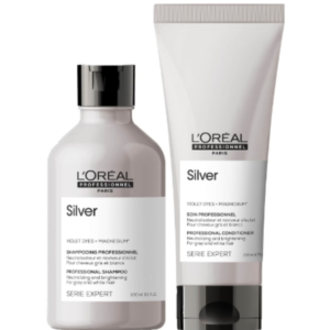 L'Oréal Professionnel Silver: Neutralización y Brillo para Cabello Blanco y Canoso Dúo de productos L'Oréal Professionnel Silver diseñado para cabello gris, blanco o decolorado. Incluye champú y acondicionador con pigmentos violetas y magnesio en envases plateados con detalles negros y blancos, ideales para neutralizar tonos amarillentos y aportar luminosidad.